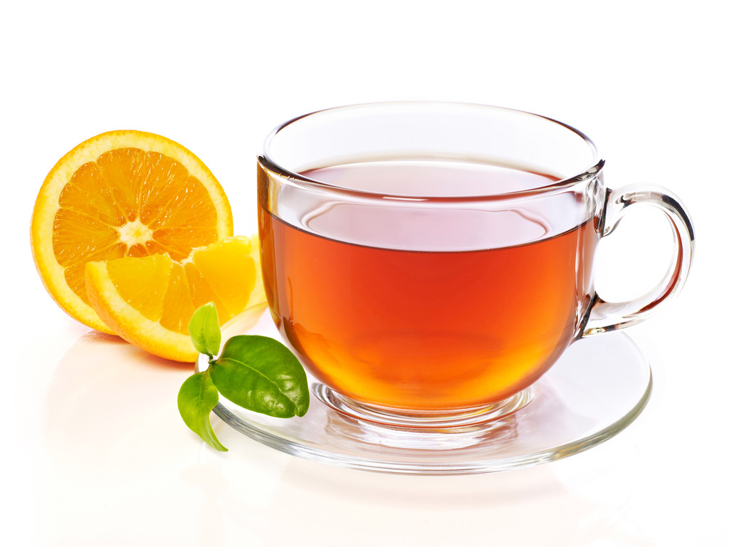 Cup of hot tea with orange slice